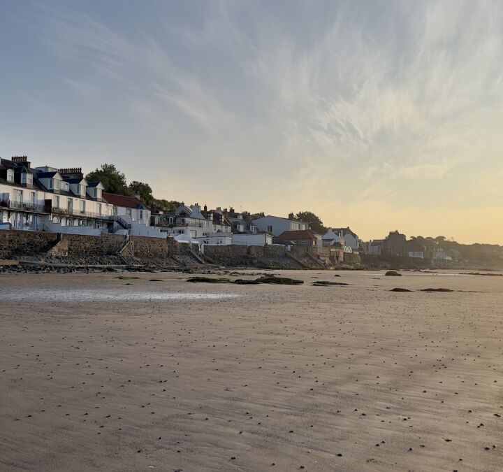Rows of houses overlooking the beach at sunset